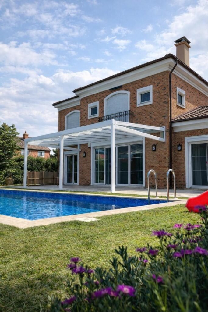 White fixed glass roof veranda over a patio next to a swimming pool, Bowdon, Manchester