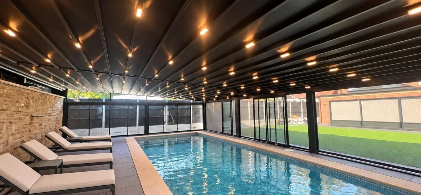 Retractable PVC roof enclosure over a swimming pool, Braemar Gardens, London