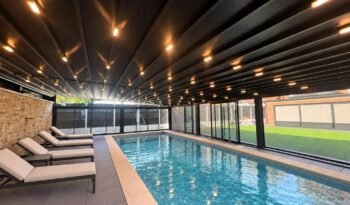 Retractable PVC roof enclosure over a swimming pool, Braemar Gardens, London