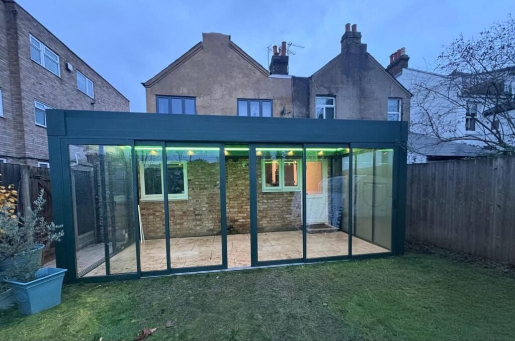 Motorised retractable glass roof garden room with sliding doors, Graham Road, London