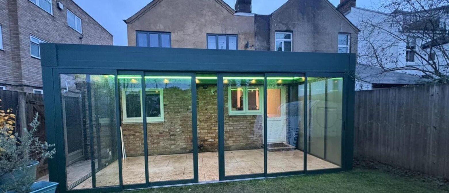 Motorised retractable glass roof garden room with sliding doors, Graham Road, London