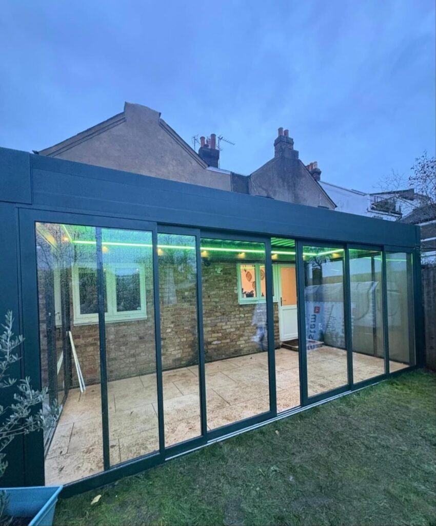 Motorised retractable glass roof garden room with sliding doors, Graham Road, London