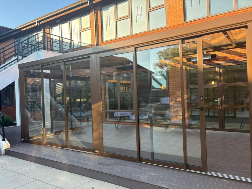 Fixed glass roof extension with sliding glass doors at Horwood House Hotel, Milton Keynes