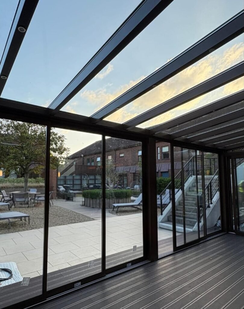 Fixed glass roof extension with sliding glass doors at Horwood House Hotel, Milton Keynes