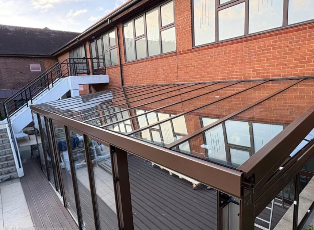 Fixed glass roof extension with sliding glass doors at Horwood House Hotel, Milton Keynes