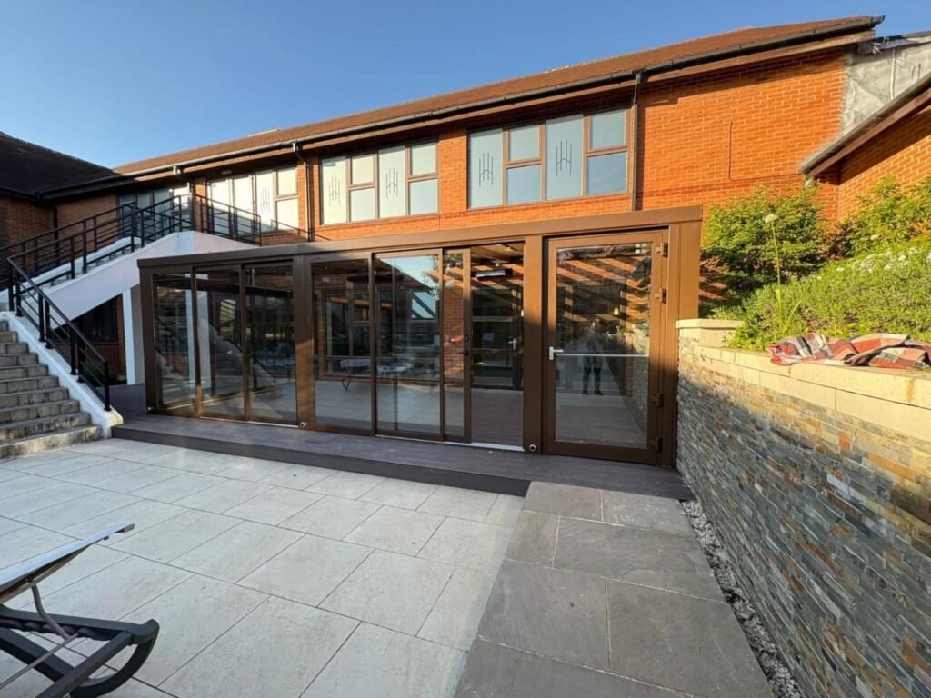 Fixed glass roof extension with sliding glass doors at Horwood House Hotel, Milton Keynes